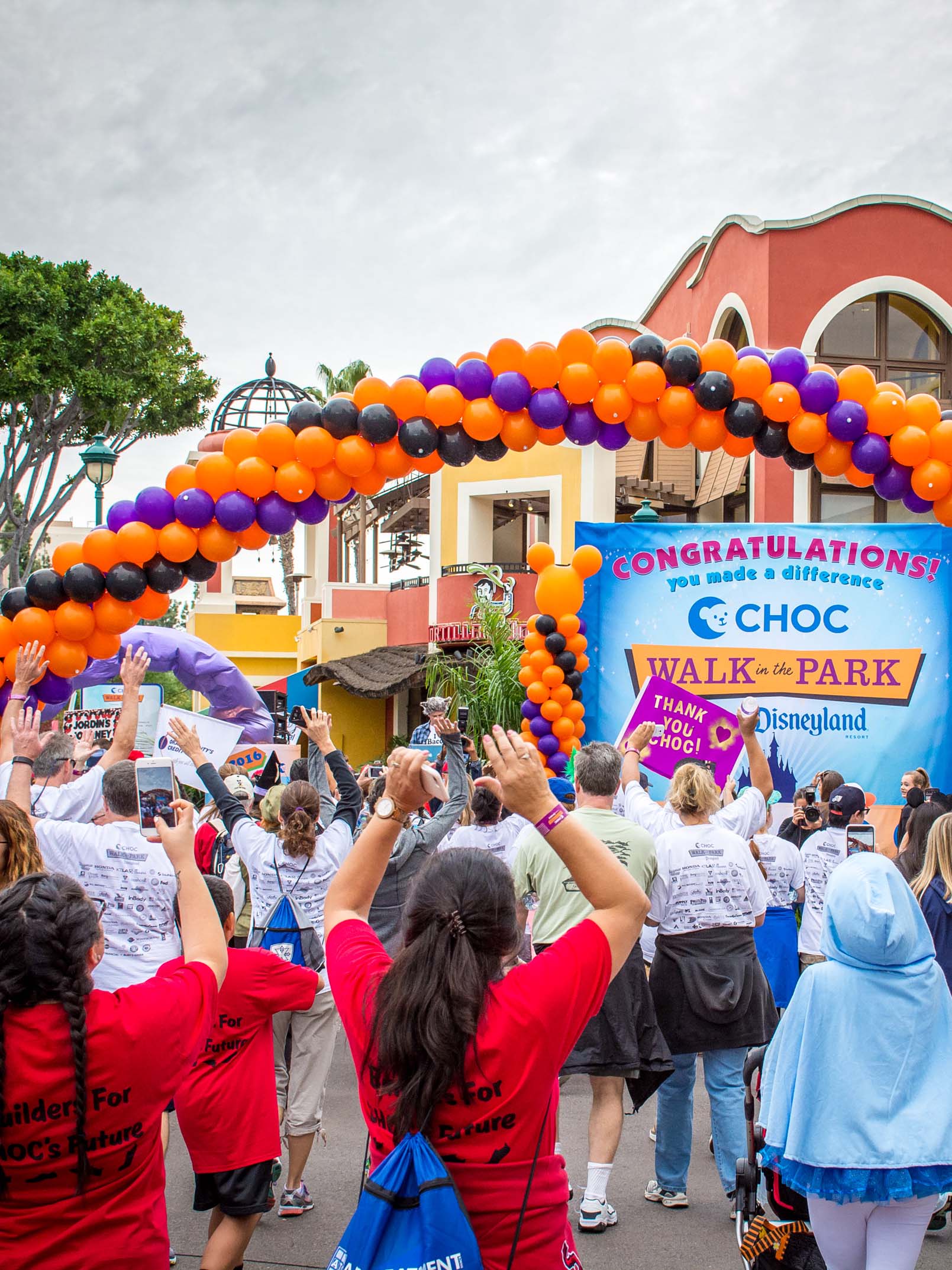 crowd of people walking through Downtown Disney for CHOC walk in the park