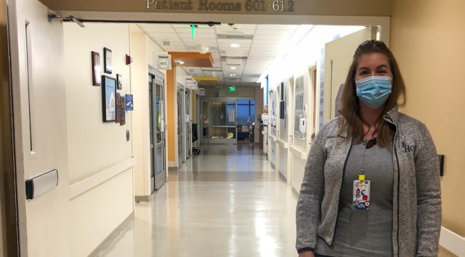 CHOC CVICU nurse, Amanda, standing in front of the CVICU entrance